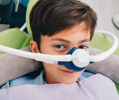 child using pediatric dental sedation, laughing gas