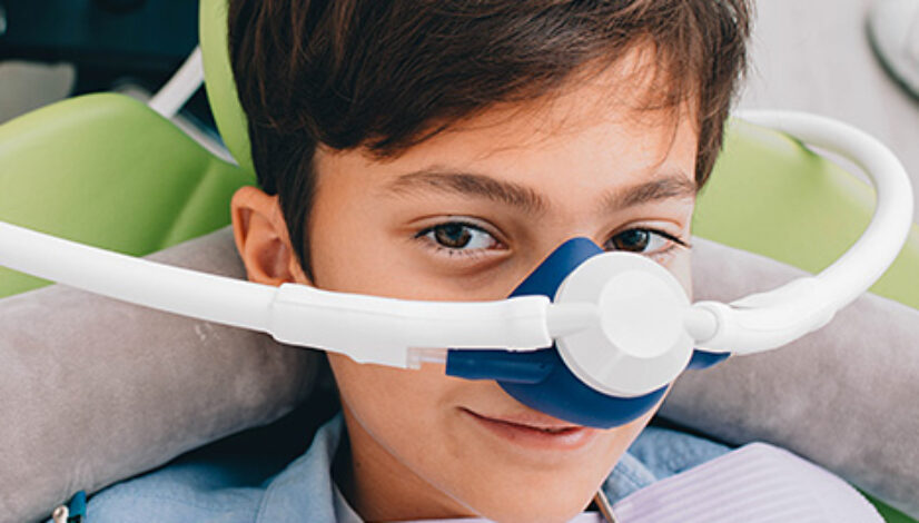 child using pediatric dental sedation, laughing gas